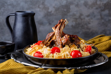 Slow roasted lamb meat on buns with saffron long rice and vegetables, onion, tomatoes, almond....