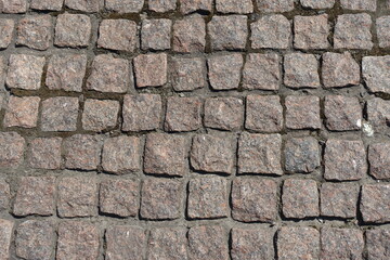 Background - pavement made of rectangular pink granite stone setts