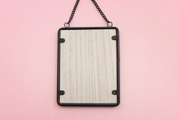 Image of black metal vintage empty photo frame over pastel pink background. For mockup, can be used for photography montage