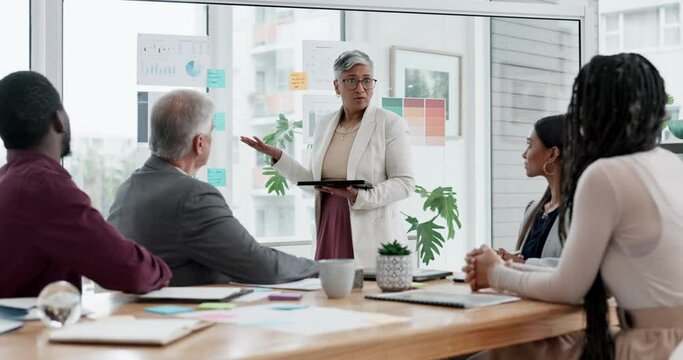 Senior woman, tablet and coaching in meeting or presentation for strategy, planning or ideas at the office. Female person, CEO or manager training staff with technology on glass board in conference