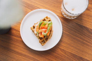 Toast with cheese and red fish on a white plate with coffee.
