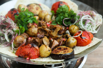 Fototapeta na wymiar Grilled meat with vegetables and flatbread