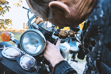 A man repairs a retro motorcycle.