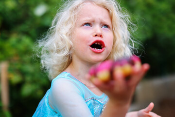 Cute little girl surprised of pink donut