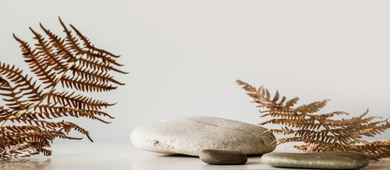Minimal modern product display on a neutral beige background. Stone podium and tropical leaves. Concept stage showcase for new product, advertising sale, banner, presentation, cosmetics