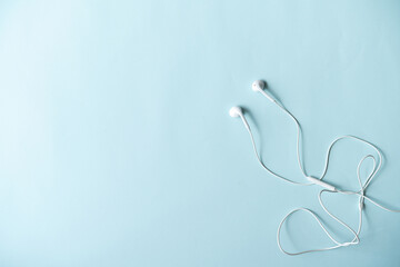 Top view of earphones with accessories on blue background ,Online learning design concept. Top view of  ,Top view with copy space for text