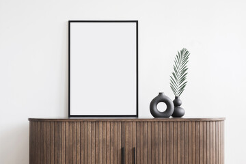 Black empty frame mockup on white wall in modern interior, Artwork template mock up in interior design, View of modern scandinavian style interior with trendy vase