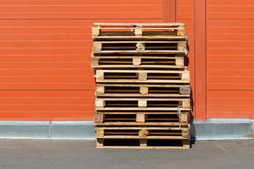 Pallets stacked near warehouse wall