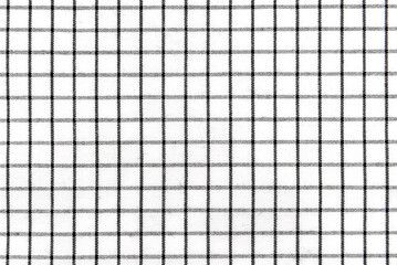 The texture of linen fabric in a large cell of black and white. Scottish tailoring material. checkered fabric