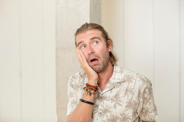 young blond adult man feeling bored, frustrated and sleepy after a tiresome, dull and tedious task,...