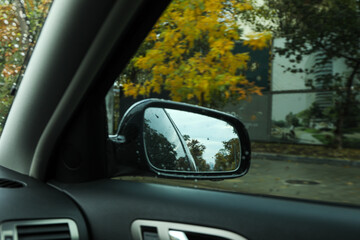 Fototapeta na wymiar Rearview mirror of a car in rainy weather