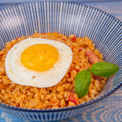 RECIPE FOR BLE WITH BACON, TOMATO AND SHALLOTS, SERVED WITH FRIED EGG. High quality photo