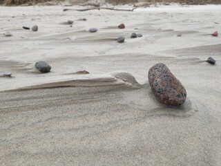 Beach sand with stones in the wind with strange shapes