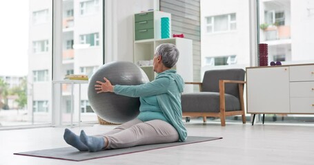 Senior woman stretching with ball for exercise, wellness and workout in retirement in yoga studio. Old lady, twist movement and mobility with fitness equipment on floor, mat and care of healthy body
