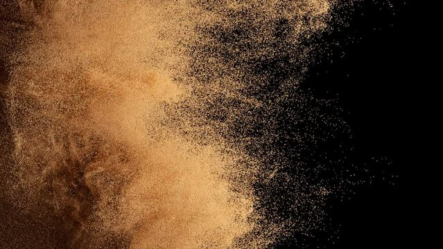 Bronze particles fly on a black background. The wind blows away colored sand. Powder. Spray. Texture. 3d animation.