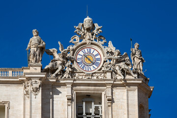 Facade of  Saint Peter's Basilica with decorative clock on a top, Vatican, Rome, Italy