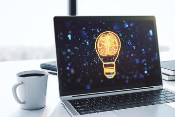 Modern computer monitor with creative light bulb hologram with human brain, idea and brainstorming concept. 3D Rendering
