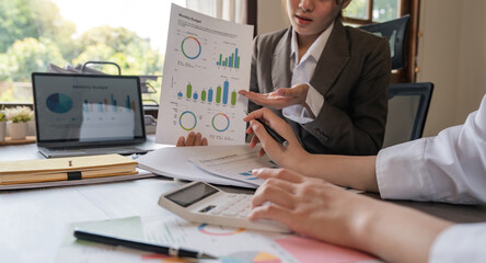 Teamwork of business two colleagues analysis with financial data and marketing report graph, Young...