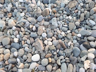 Abstract background of gray numerous rocky sea pebbles