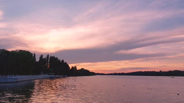 Beautiful sunset with colorful cloudy sky over the river in the evening