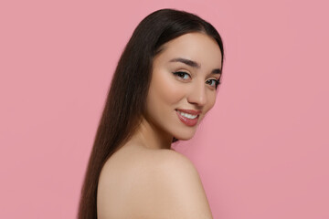 Fototapeta premium Portrait of beautiful young woman with elegant makeup on pink background