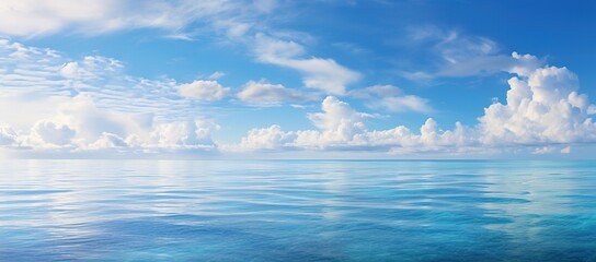 tropical beach panorama, seascape with a wide horizon, showcasing the beautiful expanse of the sky meeting the sea - obrazy, fototapety, plakaty