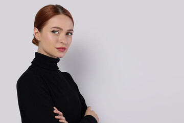 Fototapeta premium Portrait of beautiful young woman on light gray background, space for text