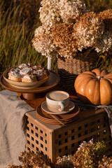 Cup of tasty coffee on table in outdoor cafe. Fall mood