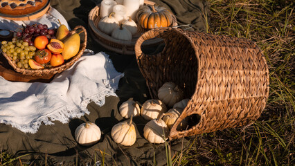 Pumpkins with flowers and rustic hay decoration outdoors. Stylish autumn decor of exterior building.