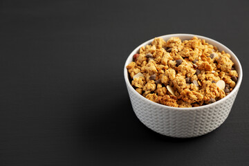 Protein Granola with hazelnut, almond, and chocolate in a Bowl, side view. Space for text.