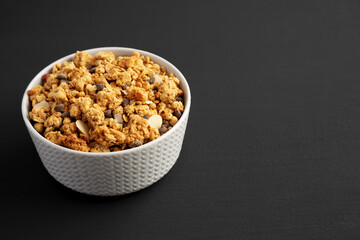 Protein Granola with hazelnut, almond, and chocolate in a Bowl, side view. Copy space.