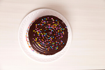 children's birthday cake, with chocolate and colorful candies on top. Cake concept. Confectionery concept.