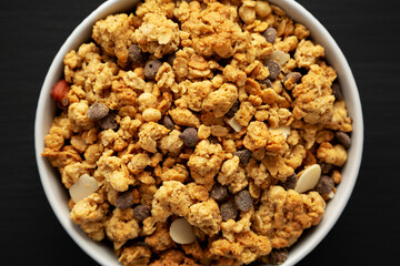 Protein Granola with hazelnut, almond, and chocolate in a Bowl, top view.