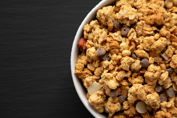 Protein Granola with hazelnut, almond, and chocolate in a Bowl, top view. Copy space.