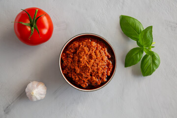 Homemade Sun Dried Tomato Pesto in a Bowl, top view. Flat lay, overhead, from above.