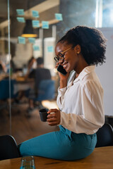 Happy businesswoman in office. Portrait of beautiful businesswoman using the phone.