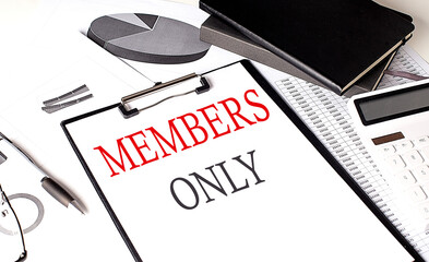 MEMBERS ONLY text on paper clipboard with chart and notebook on withe background