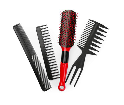 Plastic hair brush and combs isolated on white, top view