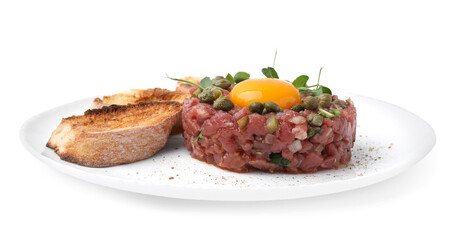 Tasty beef steak tartare served with yolk, capers, toasted bread and greens isolated on white