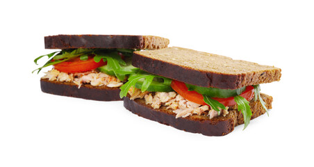 Delicious sandwiches with tuna and vegetables on white background