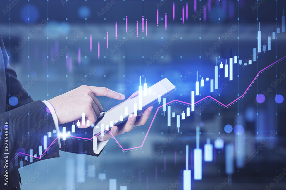 Poster close up of businessman hands pointing at cellphone with glowing candlestick forex chart on blurry o