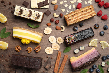 Flat lay composition with different tasty cakes on wooden table