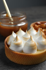 Tartlet with meringue on table, closeup. Delicious dessert