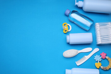 Flat lay composition with baby care products and accessories on light blue background, space for text