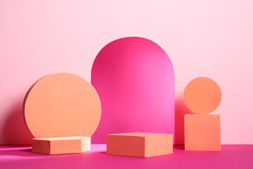 Many orange geometric figures on pink background. Stylish presentation for product