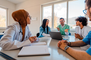 A medical team of doctors discussing at a meeting in the conference room.