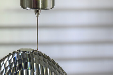 The  CMM probe measuring the head lamp lens reflection mold parts on machining center. © Pixel_B