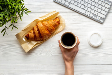 Coffee break in the office. Paper cup of coffee with keyboard, top view