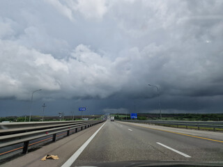 Fototapeta premium Empty highway, minimalistic photo. There are no cars and a view of the gray clouds. Natural disasters