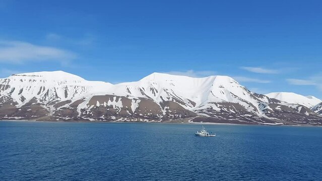 Serene Winter Landscape: Majestic Mountains, Pristine Snow, and Tranquil Sea a view from svalbard and jan mayen norway